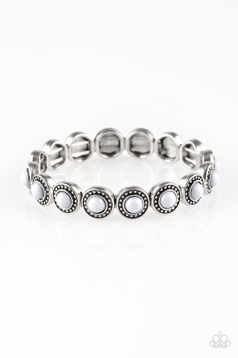 Dotted with neutral gray beaded centers, studded silver frames are threaded along stretchy elastic bands and linked around the wrist for a whimsical look.  Sold as one individual bracelet.
