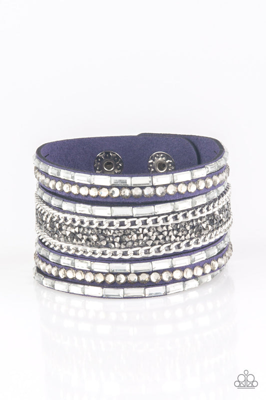 White emerald-cut rhinestones, smoky round rhinestones, and metallic prism-shaped rhinestones are sprinkled along strands of blue suede. Shimmery silver chain is added to the mix for a sassy industrial finish. Features an adjustable snap closure.  Sold as one individual bracelet.