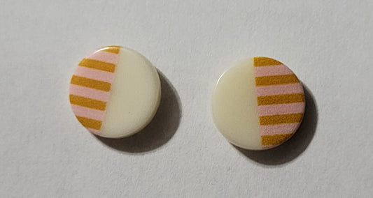 Kids' round button shaped earrings with white on one side and peach with darker peach stripes on the other