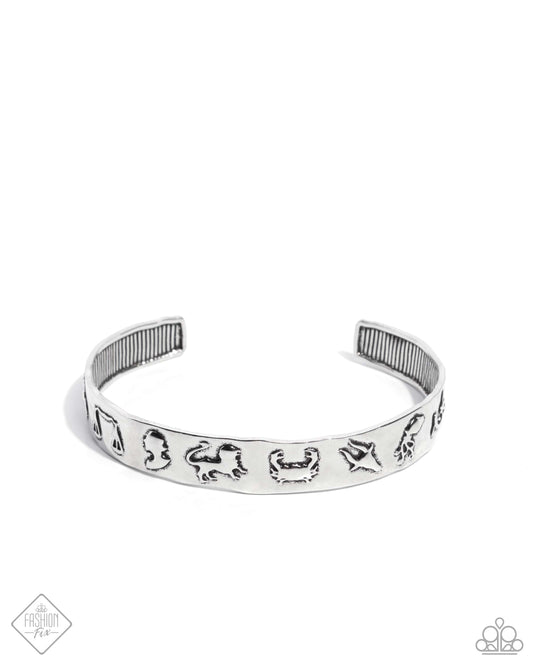 Featuring the symbols of the twelve zodiac signs, a hammered high-sheen silver cuff arcs across the wrist for an astrologically attractive look.  Sold as one individual bracelet.
