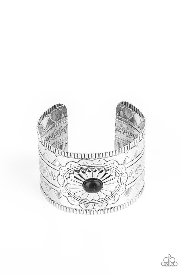 Dotted with a black stone center, a thick silver cuff is etched, stamped, and embossed in geometric tribal inspired textures for a seasonal look.  Sold as one individual bracelet.