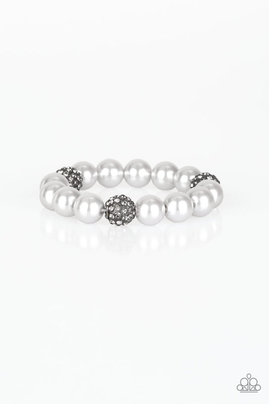 A collection of silver pearls and smoky rhinestone encrusted beads are threaded along a stretchy band around the wrist for a refined flair.

Sold as one individual bracelet.