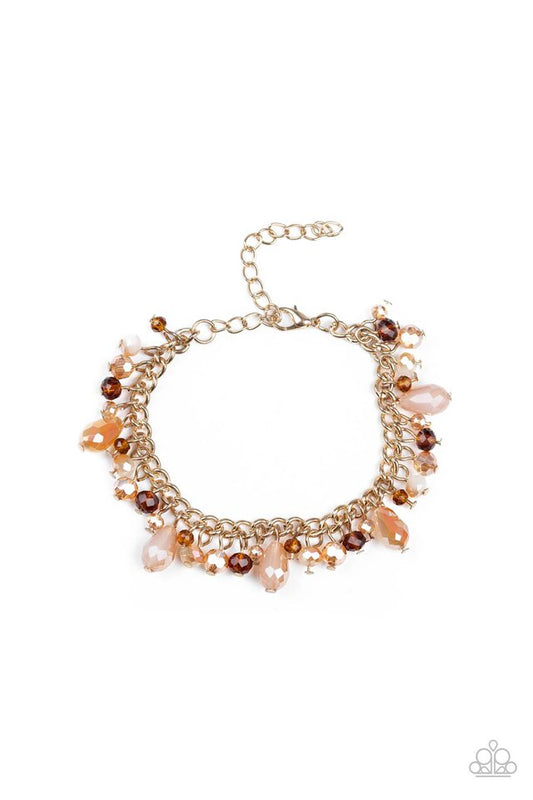 Featuring crystal-like and metallic opaque finishes, mismatched beading swings from a shimmery gold chain, creating a glamorous fringe around the wrist. Features an adjustable clasp closure.

Sold as one individual bracelet.