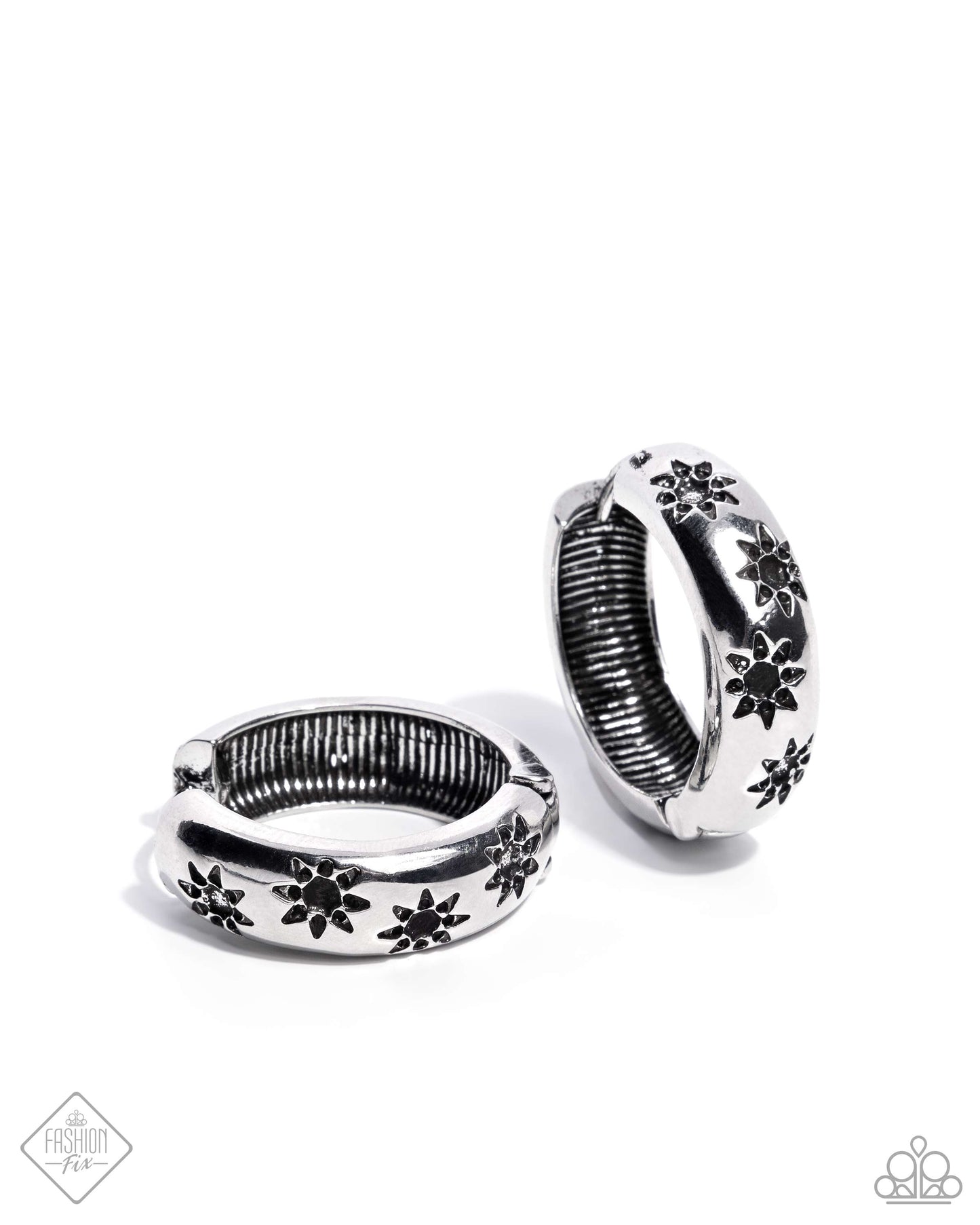 Stamped across the front of a high-sheen silver hoop, a collection of airy suns loop and curl below the ear for a celestially chic look. Earring attaches to a standard hinge closure fitting. Hoop measures approximately 1" in diameter.  Sold as one pair of hinge hoop earrings.