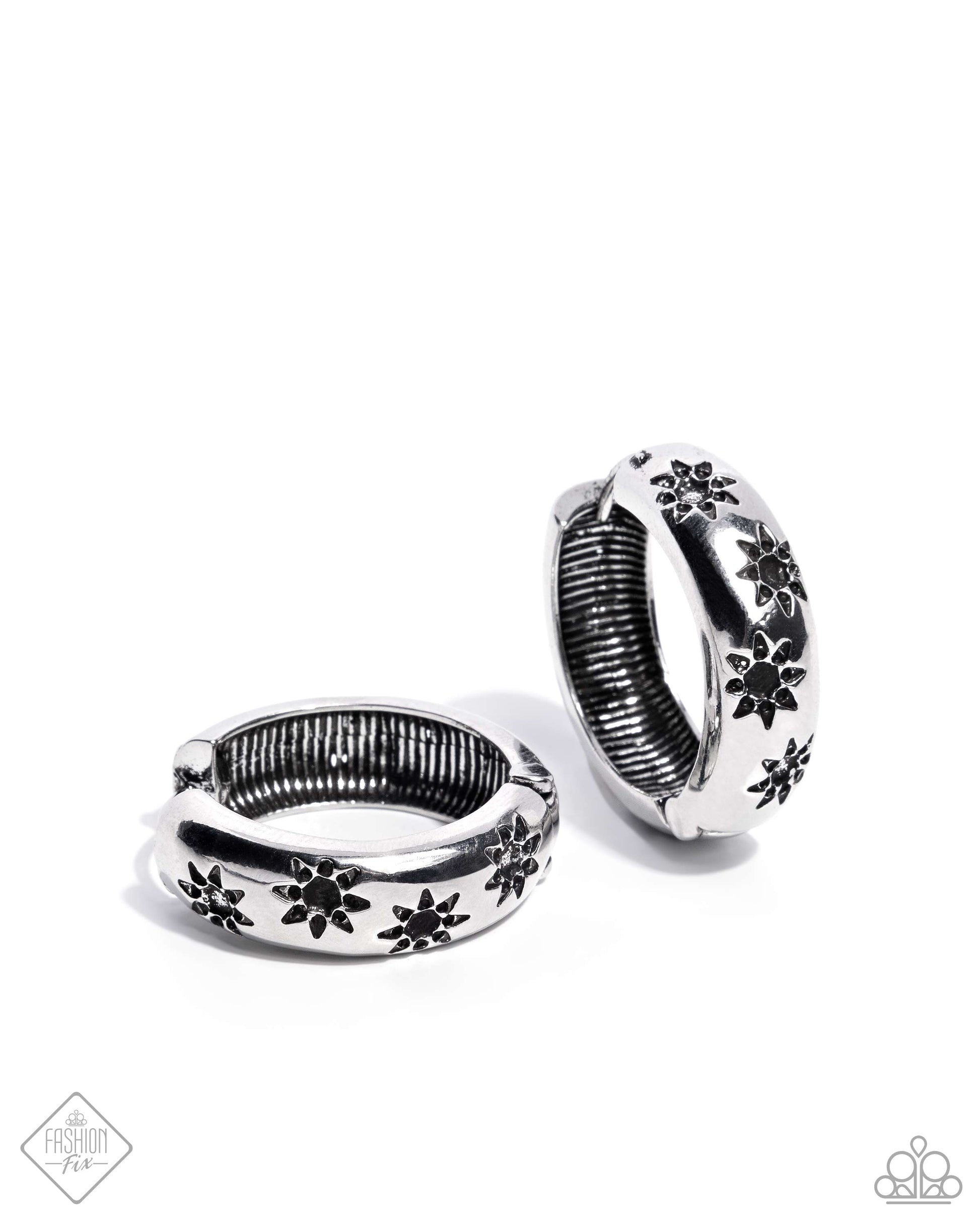 Stamped across the front of a high-sheen silver hoop, a collection of airy suns loop and curl below the ear for a celestially chic look. Earring attaches to a standard hinge closure fitting. Hoop measures approximately 1" in diameter.  Sold as one pair of hinge hoop earrings.