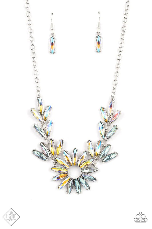 Featuring oblong marquise cuts, a collection of iridescent gems join into leafy frames below the collar. Radiating with the same iridescent intensity, even more stellar rhinestones fan out into a circular focal point, resulting in a celestial centerpiece. Features an adjustable clasp closure. Due to its prismatic palette, color may vary.  Sold as one individual necklace. Includes one pair of matching earrings.