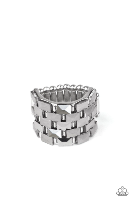 Featuring a flashy faceted surface, staggered rows of rectangular hematite rhinestones alternate with shiny silver bar-like accents across a thick silver band for a gritty-glamorous statement atop the finger. Features a stretchy band for a flexible fit.  Sold as one individual ring.