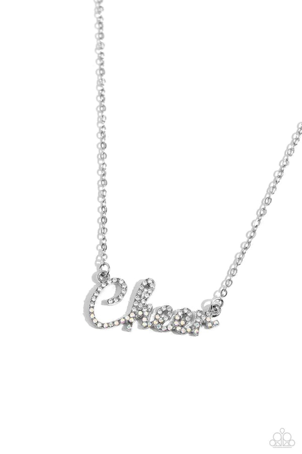 Curled in a script font, glistening silver letters spell out the word "Cheer" along a dainty silver chain. Embossed on the letters, dainty white rhinestones and iridescent rhinestones create a subtle ombré effect for a peppy finish. Features an adjustable clasp closure. Due to its prismatic palette, color may vary.  Sold as one individual necklace. Includes one pair of matching earrings.
