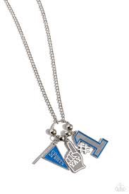 Cascading from a silver hoop, a white-painted foam finger charm with the stamped word "yay," a blue and white-painted "#1" charm, a "Sports"-stamped blue flag, and silver studs coalesce into an athletic-inspired centerpiece down the chest. Features an adjustable clasp closure.

Sold as one individual necklace. Includes one pair of matching earrings.