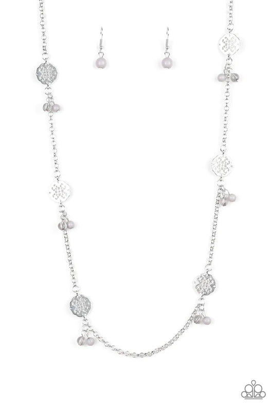 Featuring glassy and polished finishes, dainty white beads join ornate silver frames along a shimmery silver chain for a whimsical look. Features an adjustable clasp closure.  Sold as one individual necklace. Includes one pair of matching earrings.