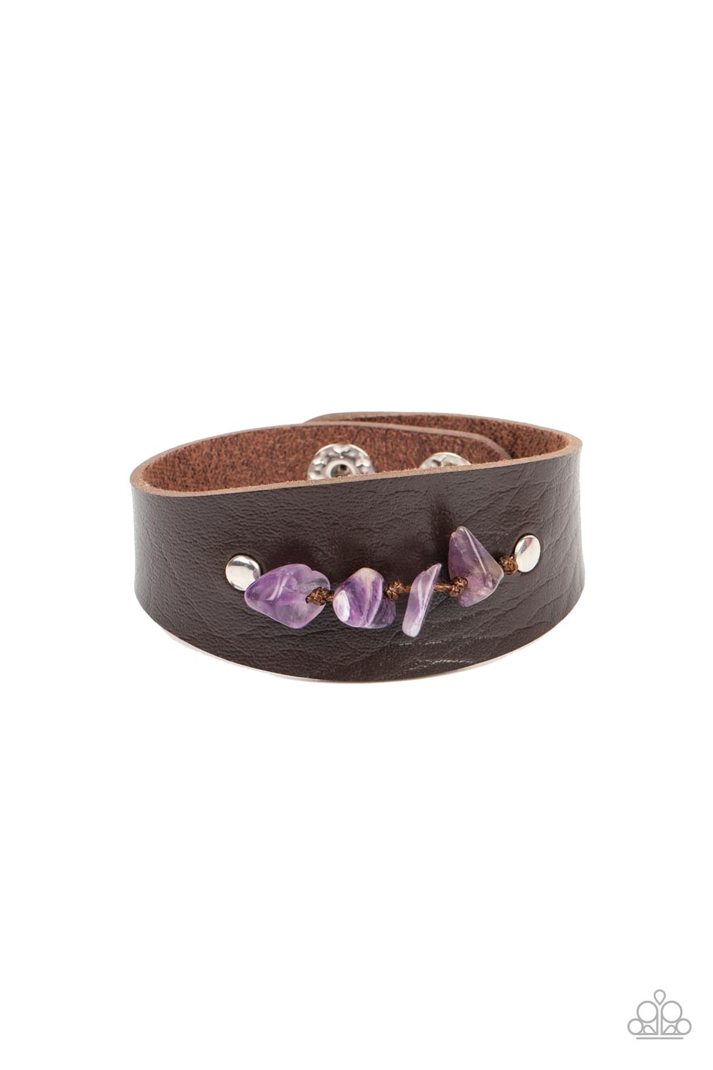 Pieces of amethyst pebbles are threaded along a brown cord that is studded in place across the front of a rounded leather band, resulting in an earthy pop of color atop the wrist. Features an adjustable snap closure.  Sold as one individual bracelet.