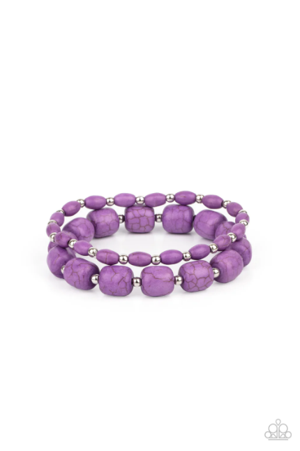 Dainty silver beads and mismatched purple stone beads are threaded along stretchy bands around the wrist, creating vivacious layers.  Sold as one pair of bracelets.
