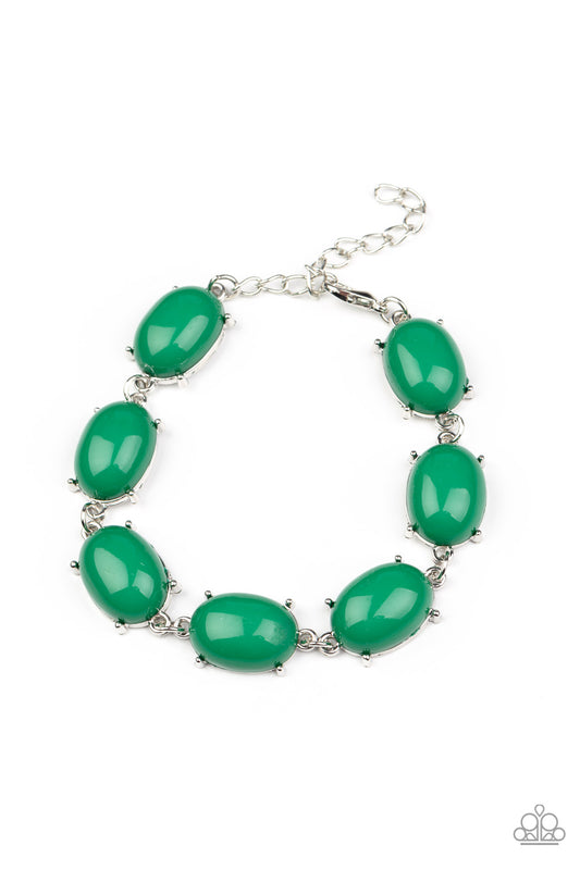 Featuring pronged silver fittings, an oversized collection of oval Leprechaun beads delicately link around the wrist for a dramatic pop of color. Features an adjustable clasp closure.  Sold as one individual bracelet.
