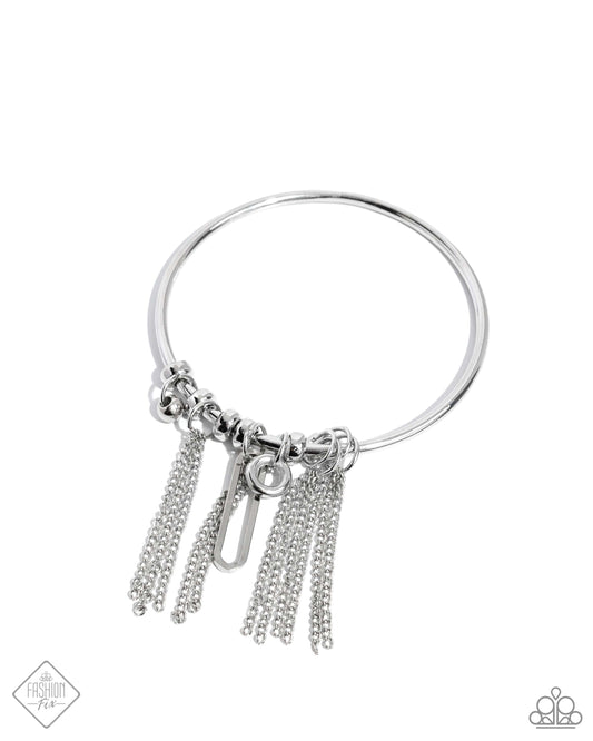 Dancing along a thin silver bangle, a collection of silver hoops, beads, classic silver chains, and a silver paperclip chain link creates a stackable, sassy look.  Sold as one individual bracelet.