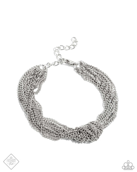 Featuring a high-sheen, abundant classic silver chains arc around the wrist, knotting at the center of the display for a subtly industrial statement. Features an adjustable clasp closure.  Sold as one individual bracelet.