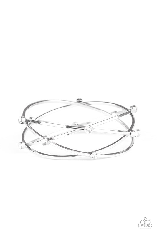 Dotted in dainty white rhinestones, dainty silver bangles crisscross and stack into one bold bracelet for a refined look.  Sold as one individual bracelet.