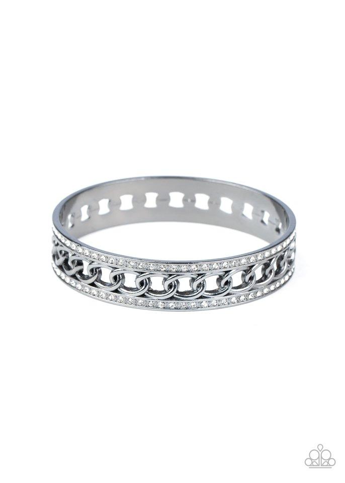 Bordered in rows of blinding white rhinestones, a glistening strand of gunmetal chain glamorously links around the wrist, coalescing into an unapologetically glittery bangle.  Sold as one individual bracelet.