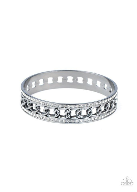 Bordered in rows of blinding white rhinestones, a glistening strand of gunmetal chain glamorously links around the wrist, coalescing into an unapologetically glittery bangle.  Sold as one individual bracelet.