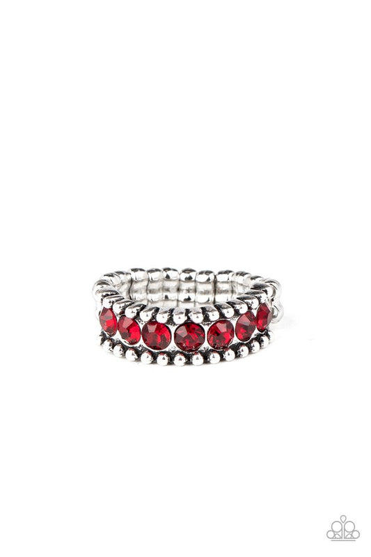 A band of dainty red rhinestones is nestled between two rows of antiqued silver studs, coalescing into an edgy shimmer across the finger. Features a dainty stretchy band for a flexible fit.  Sold as one individual ring.