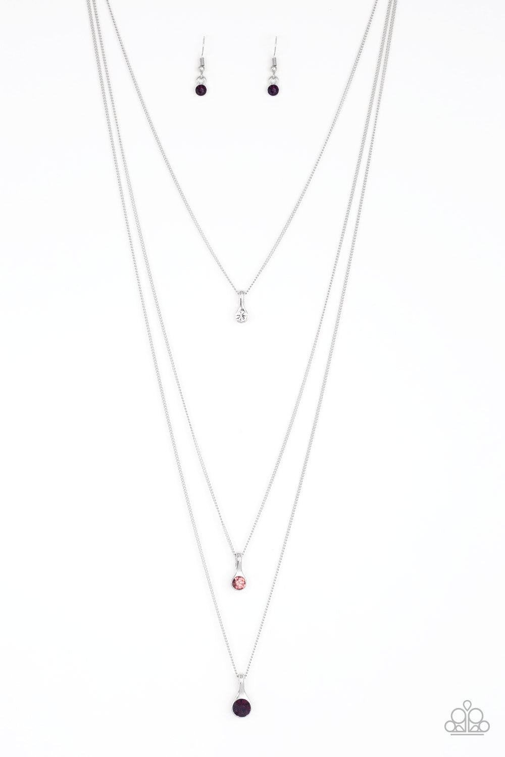 Gradually increasing in size as they drip down the chest, a trio of white, light pink, and pink rhinestone pendants trickle from the bottoms of layered silver chains for a delicate ombre effect. Features an adjustable clasp closure.  Sold as one individual necklace. Includes one pair of matching earrings.
