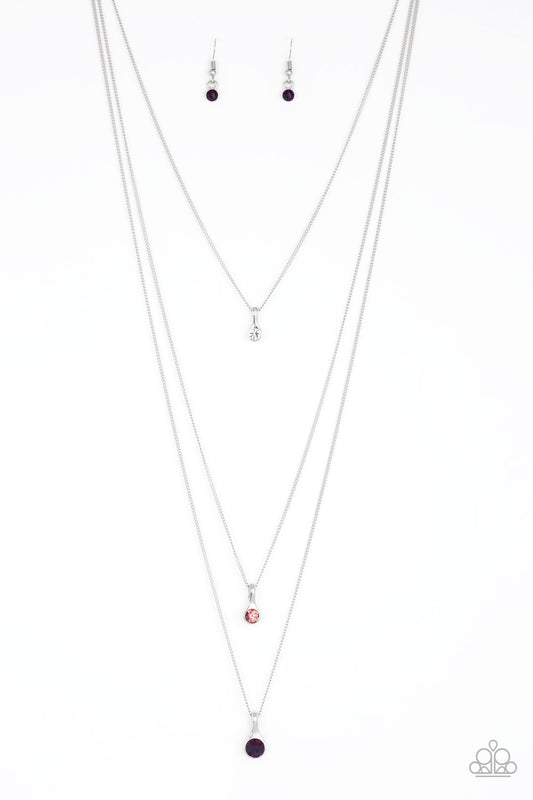 Gradually increasing in size as they drip down the chest, a trio of white, light pink, and pink rhinestone pendants trickle from the bottoms of layered silver chains for a delicate ombre effect. Features an adjustable clasp closure.  Sold as one individual necklace. Includes one pair of matching earrings.