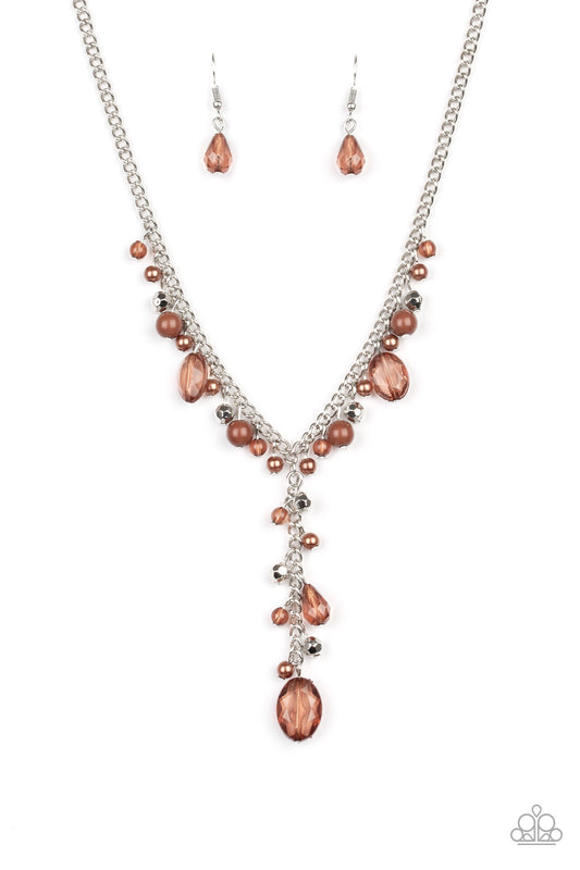 Mismatched polished brown beads, crystal-like beads, and faceted silver beads dance along a shimmery silver chain. Matching beading trickles along a single silver chain, creating a romantic extended pendant below the collar. Features an adjustable clasp closure.  Sold as one individual necklace. Includes one pair of matching earrings.