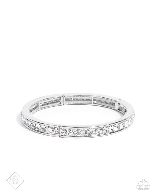 Infused along elastic stretchy bands, thin silver fittings embellished in a single stack of glistening white rhinestones encircle the wrist for a simply stunning statement.  Sold as one individual bracelet.