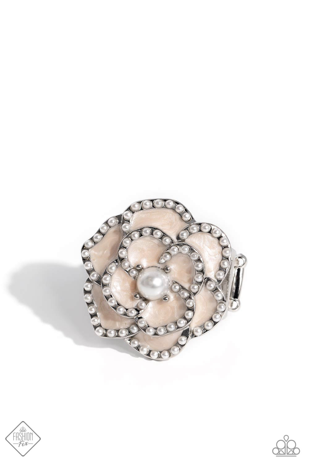 Layers of Tender Peach pearl-painted, heart-shaped petals curve around a white pearl center, creating an airy three-dimensional flower. Dainty white pearls dot along each curved petal adding refinement to the whimsical centerpiece atop the finger. Features a stretchy band for a flexible fit.  Sold as one individual ring.