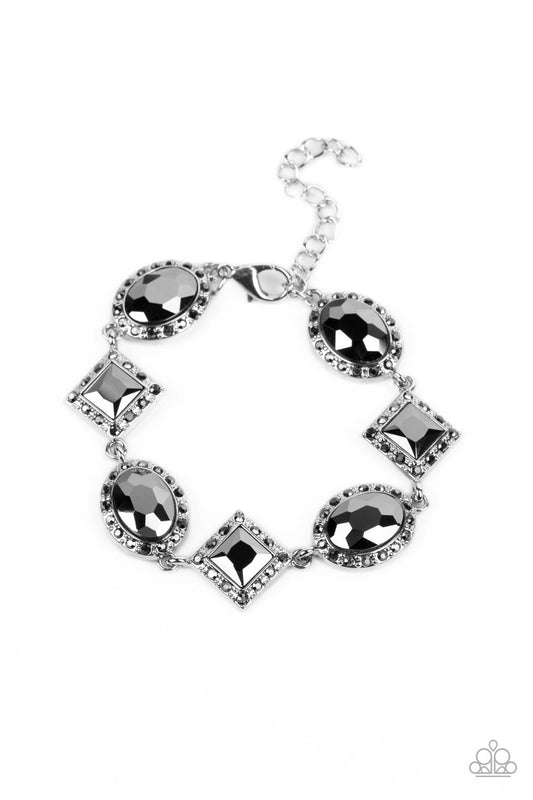 Square-cut and oval shaped hematite rhinestones are pressed into silver frames and bordered by tiny hematite rhinestones. The square-cut gems are tilted on point as they connect to the rounded ovals, alternating as they wrap around the wrist in a glamorous finish. Features an adjustable clasp closure.  Sold as one individual bracelet.