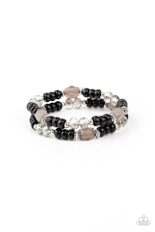 A shiny collection of smoky gems, dainty silver accents, white crystal-like beads, and polished black beads are threaded along stretchy bands around the wrist for a whimsically layered look.

Sold as one pair of bracelets.