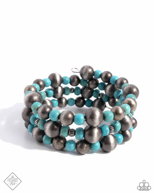 Threaded along a coiled wire, a collection of Navajo pearls, turquoise beads, and silver beads in varying sizes loop around the wrist creating a desert-inspired infinity wrap-style bracelet. As the stone elements in this piece are natural, some color variation is normal.  Sold as one individual bracelet.