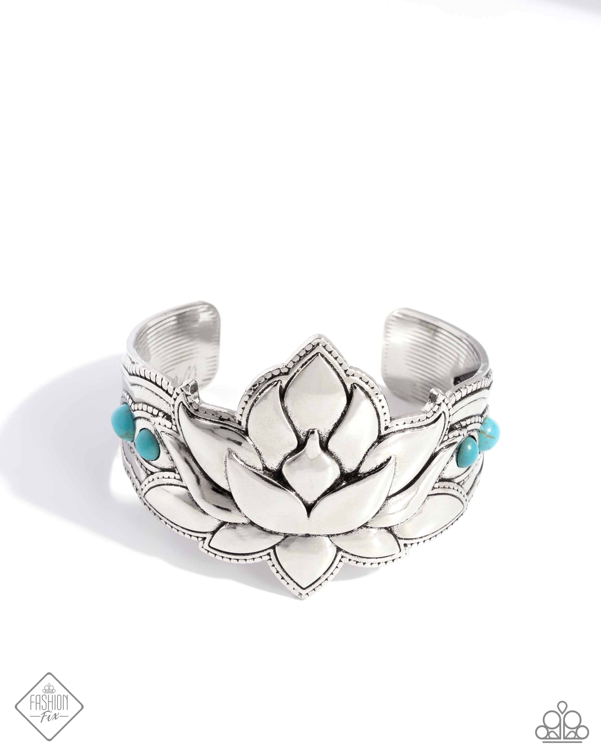 Inspired by a Lotus flower, a thick, oversized silver cuff is dotted with a collection of turquoise stones for a seasonal, earthy look. As the stone elements in this piece are natural, some color variation is normal.  Sold as one individual bracelet.
