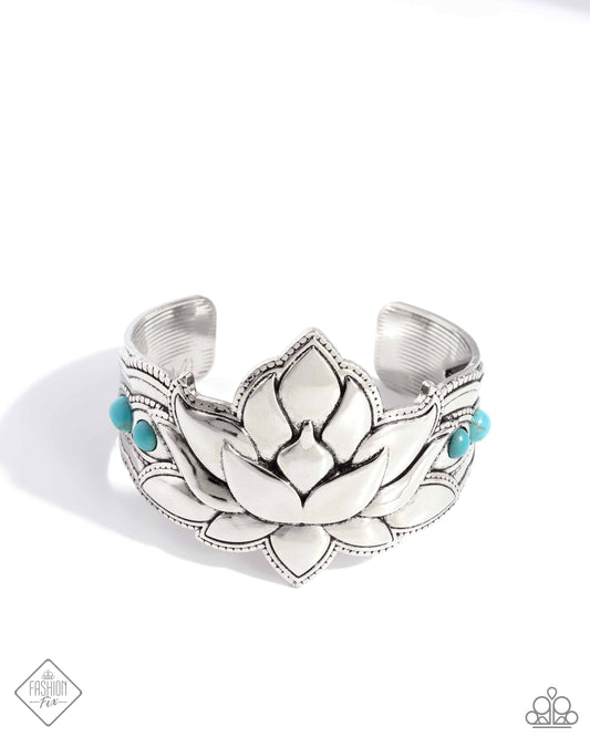 Inspired by a Lotus flower, a thick, oversized silver cuff is dotted with a collection of turquoise stones for a seasonal, earthy look. As the stone elements in this piece are natural, some color variation is normal.  Sold as one individual bracelet.