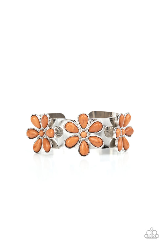 Dotted with brown stone centers, a trio of brown stone petaled flowers bloom atop a thick silver cuff for a whimsical pop of floral fashion.  Sold as one individual bracelet.