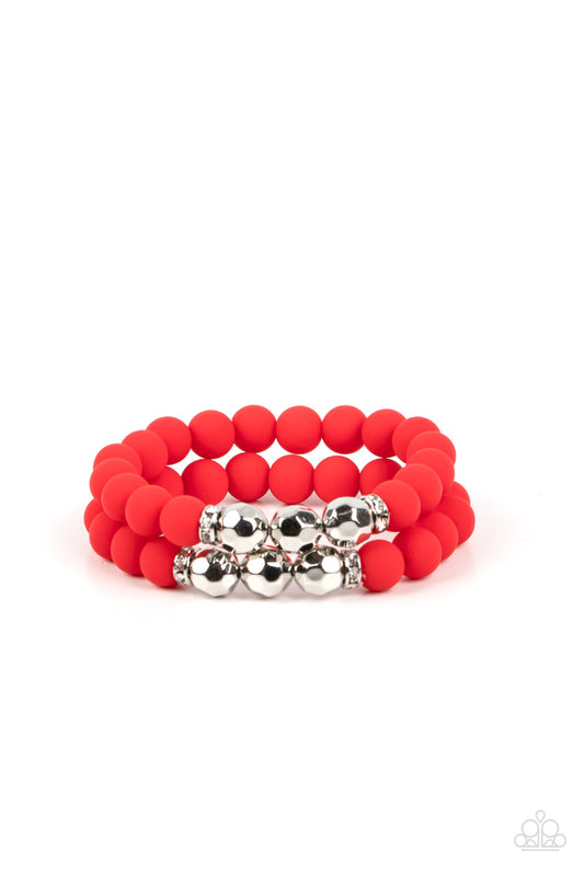 White rhinestone encrusted rings flank a trio of faceted silver beads along a stretchy row of matte-finished Poinciana beads, creating a summery splash of color around the wrist.  Sold as one individual bracelet.