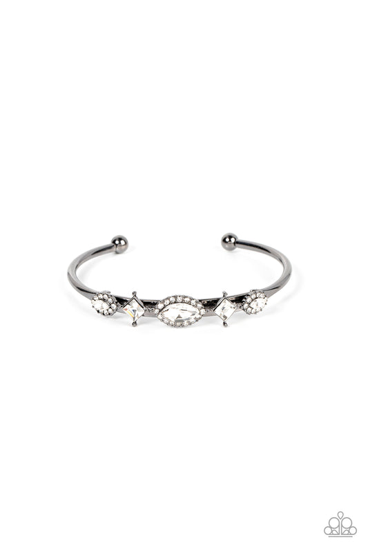 Bordered in glassy white rhinestones, a dainty arrangement of marquise cut rhinestones alternates with tilted square cut rhinestones across the front of a dainty gunmetal cuff for a surprisingly sparkly finish.  Sold as one individual bracelet.