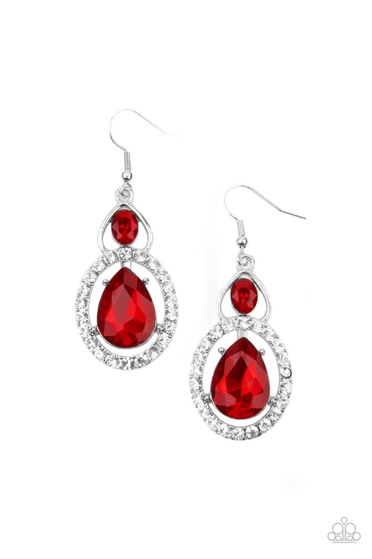 An oversized red teardrop gem is nestled inside a ring of glassy white rhinestones that attaches to an airy silver fitting adorned with a fiery oval rhinestone. Earring attaches to a standard fishhook fitting.  Sold as one pair of earrings.