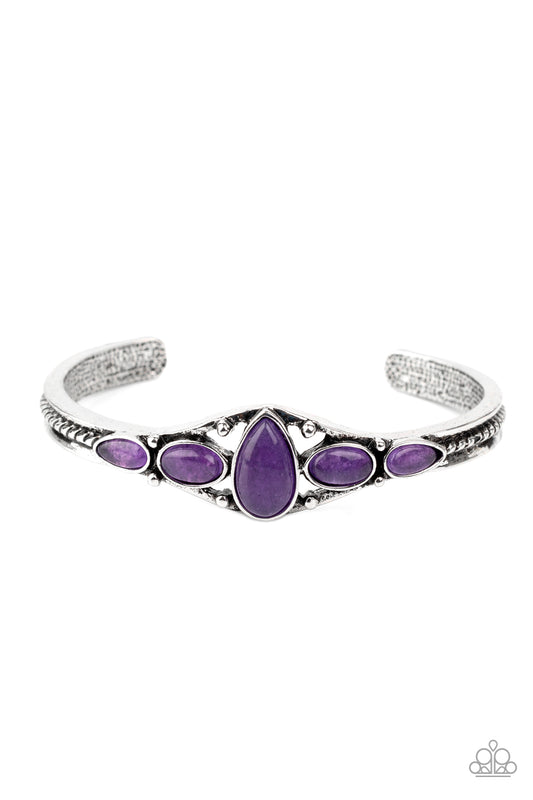 A vivacious collection of purple stones are encrusted across the front of a dainty silver cuff for a seasonal flair.  Sold as one individual bracelet.