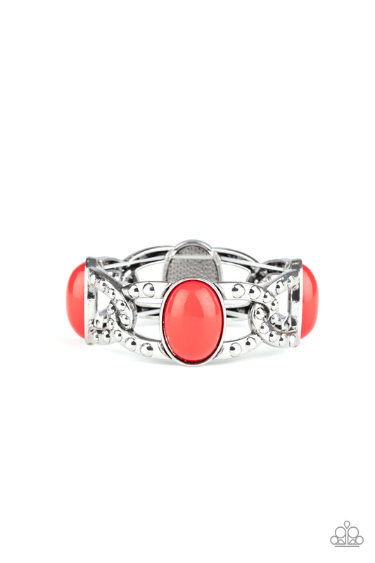 Oversized red beads and interwoven silver frames are threaded along stretchy bands around the wrist. The silver frames are dotted in antiqued studs, adding tactile texture to the colorful piece.  Sold as one individual bracelet.