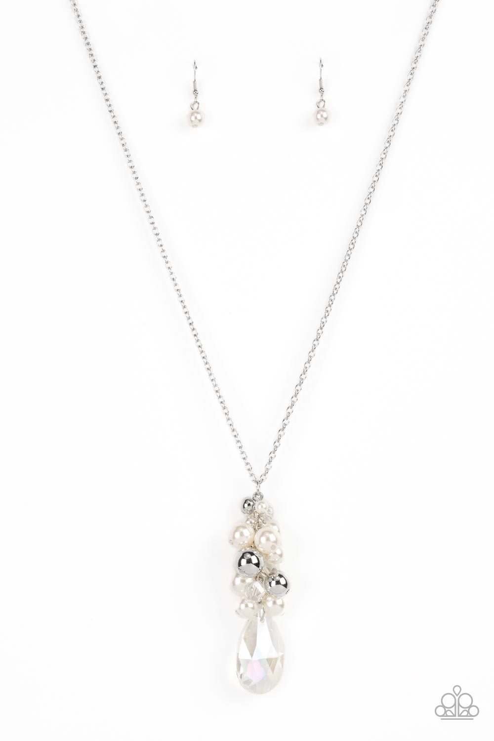 Featuring an iridescent shimmer, a dramatically oversized crystal-like teardrop swings from the bottom of a cluster of shiny silver, pearly white, and crystal-like beads, creating a dazzling pendant at the bottom of a lengthened silver chain. Features an adjustable clasp closure.  Sold as one individual necklace. Includes one pair of matching earrings.