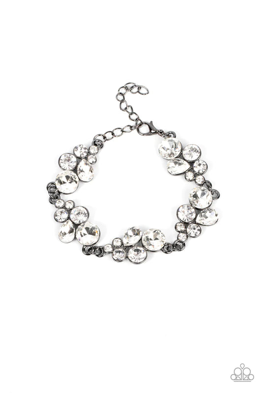 Featuring sleek gunmetal frames, clusters of round and teardrop white rhinestones delicately link around the wrist for a dash of effervescent elegance. Features an adjustable clasp closure.  Sold as one individual bracelet.