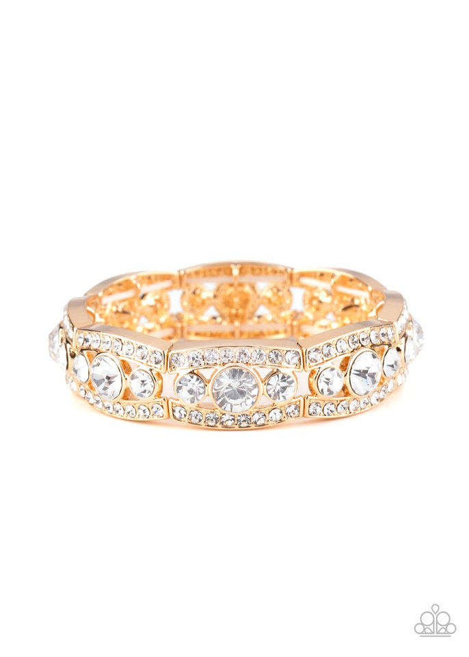 Rhinestone encrusted gold bars flank a dazzling trio of oversized white rhinestones, coalescing into a glittery frame. The sparkly frames are threaded along stretchy bands around the wrist, creating an irresistible shimmer.  Sold as one individual bracelet.