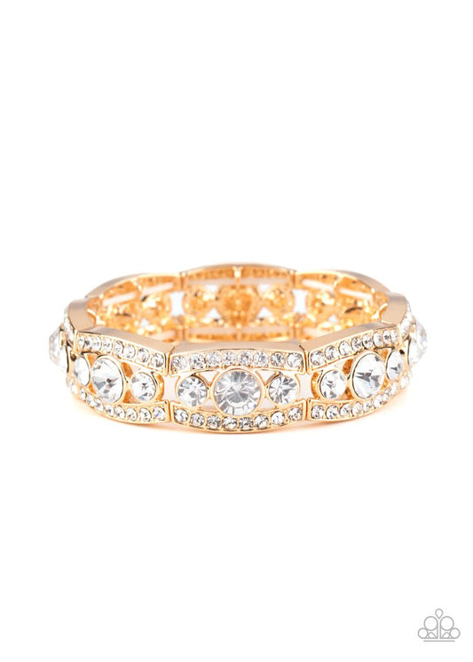 Rhinestone encrusted gold bars flank a dazzling trio of oversized white rhinestones, coalescing into a glittery frame. The sparkly frames are threaded along stretchy bands around the wrist, creating an irresistible shimmer.  Sold as one individual bracelet.