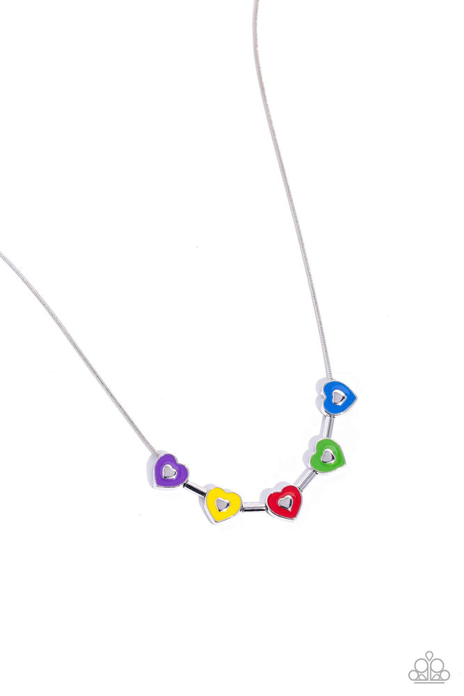 Strung along a dainty silver chain, a collection of silver heart frames, and silver bars alternate for a dainty display around the collar. Each heart is painted in a French Blue, Classic Green, red, High Visibility, and purple hue with dainty silver hearts glistening at their centers for a pop of colorful detail. Features an adjustable clasp closure.  Sold as one individual necklace. Includes one pair of matching earrings.
