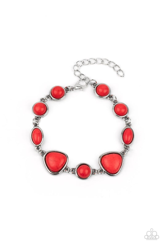 Encased in sleek silver frames, a collection of round, oval, and triangular red stones delicately link around the wrist for a one-of-a-kind look with an artisan feel. Features an adjustable clasp closure.  Sold as one individual bracelet.