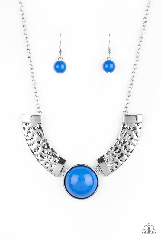 Dramatic silver plates connect with a shiny blue beaded center, creating an indigenous collar-like pendant. The shiny silver plates are delicately hammered, adding a flashy metallic texture to the tribal inspired palette. Features an adjustable clasp closure.  Sold as one individual necklace. Includes one pair of matching earrings.