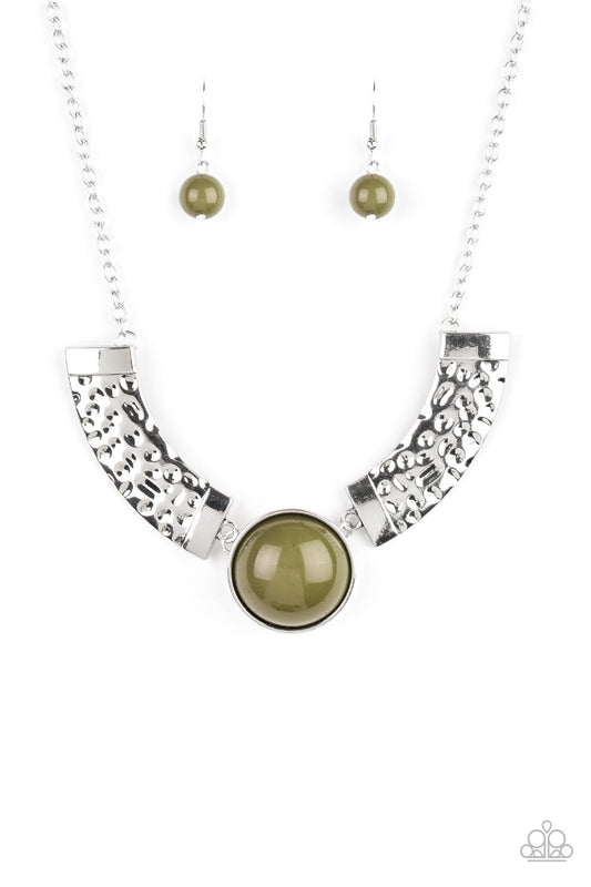 Dramatic silver plates connect with a shiny green beaded center, creating an indigenous collar-like pendant. The shiny silver plates are delicately hammered, adding a flashy metallic texture to the tribal inspired palette. Features an adjustable clasp closure.  Sold as one individual necklace. Includes one pair of matching earrings.