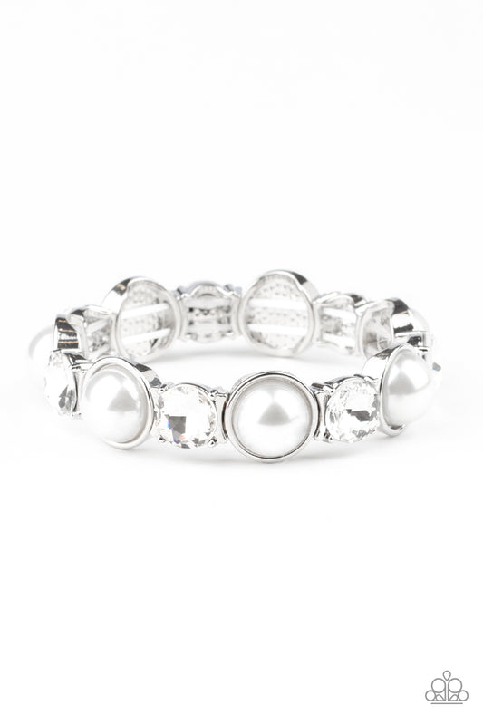 Featuring sleek silver fittings, bubbly white pearls and oversized white rhinestones are delicately threaded along stretchy bands around the wrist for a refined flair.

Sold as one individual bracelet.