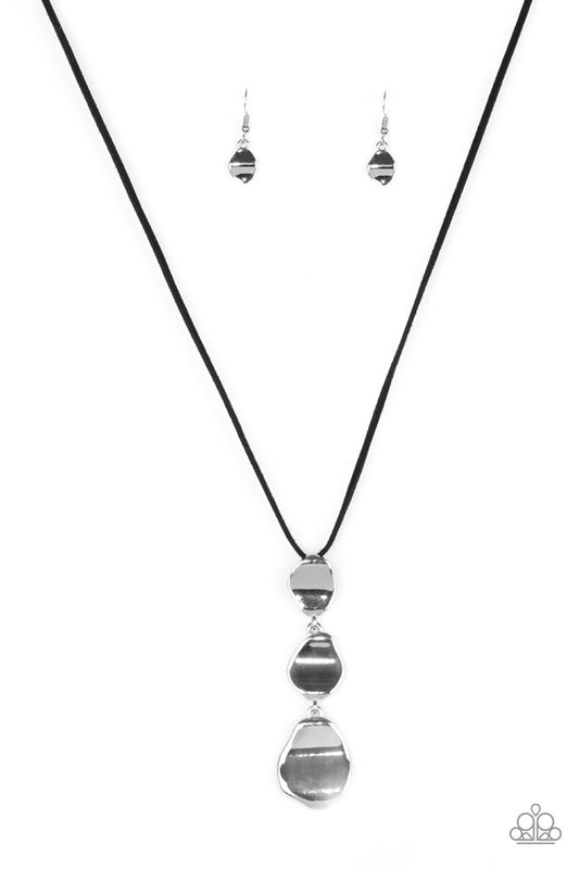 Delicately hammered in a glistening shimmer, asymmetrical silver frames link at the bottom of a lengthened black suede strand for a bold artisanal look. Features an adjustable clasp closure.  Sold as one individual necklace. Includes one pair of matching earrings.