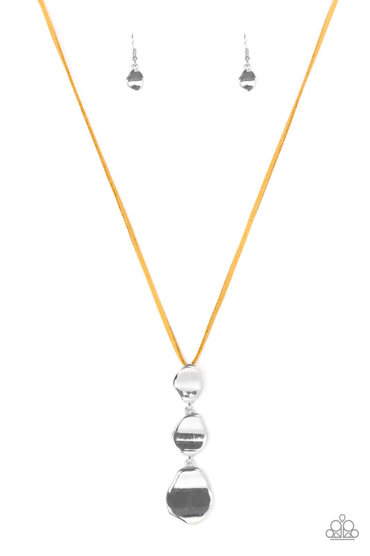 Delicately hammered in a glistening shimmer, asymmetrical silver frames link at the bottom of a lengthened orange suede strand for a bold artisanal look. Features an adjustable clasp closure.  Sold as one individual necklace. Includes one pair of matching earrings.